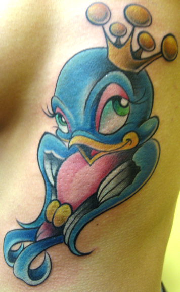 Looking for unique  Tattoos? bird on ribs tattoo